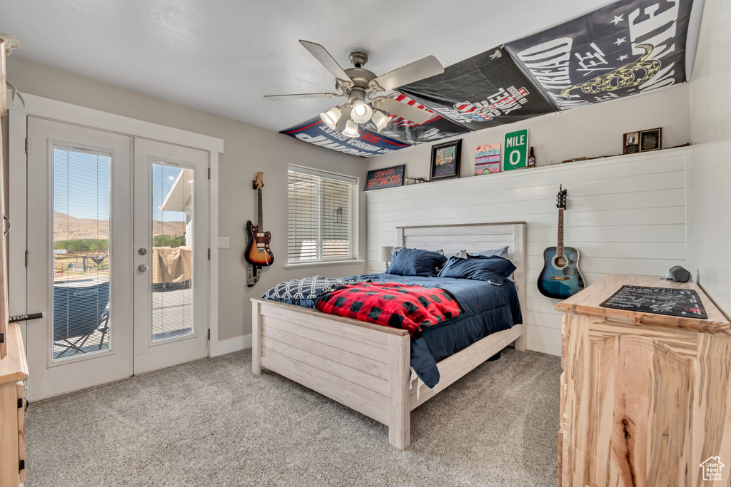 Carpeted bedroom with french doors, access to outside, and ceiling fan