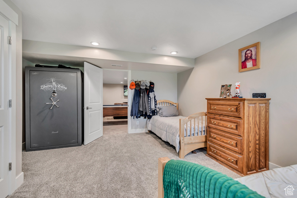 Bedroom featuring light carpet, recessed lighting, and baseboards