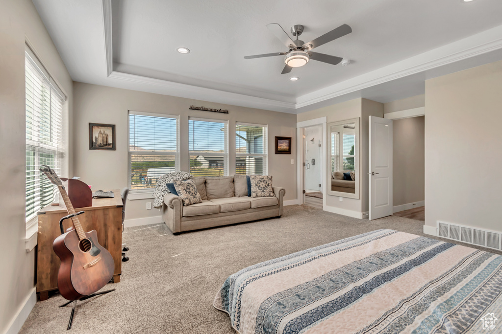 Carpeted bedroom with a tray ceiling, baseboards, recessed lighting, and ceiling fan
