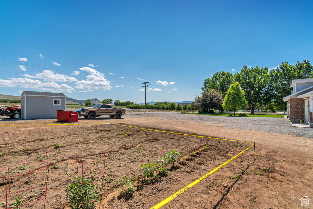 View of yard with a mountain view and an outdoor structure