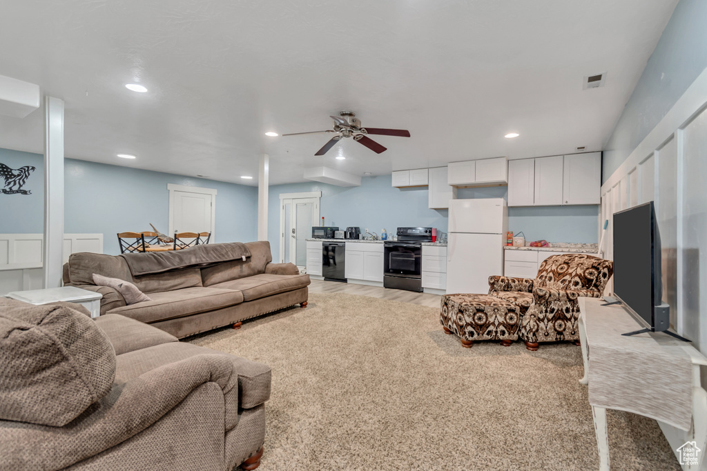 Living room featuring ceiling fan and recessed lighting