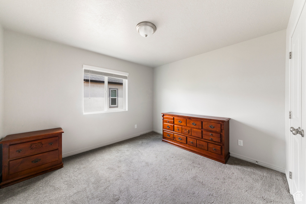 Bedroom featuring carpet floors and baseboards