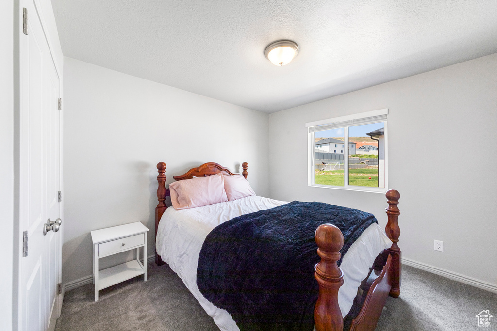 Carpeted bedroom featuring baseboards