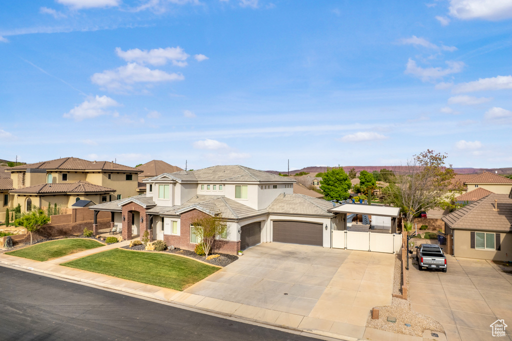 View of front of home featuring a residential view, an attached garage, driveway, and stucco siding
