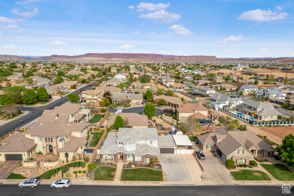 Aerial view of property's location featuring nearby suburban area and a mountain backdrop