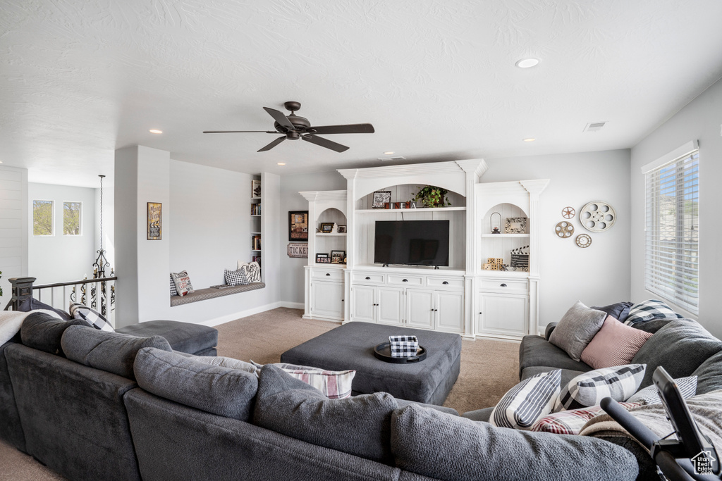 Living room with light carpet, ceiling fan, recessed lighting, and baseboards
