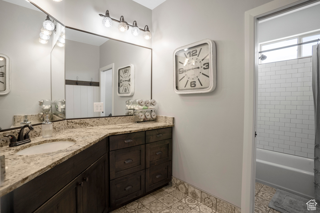 Bathroom with vanity and shower / bath combination