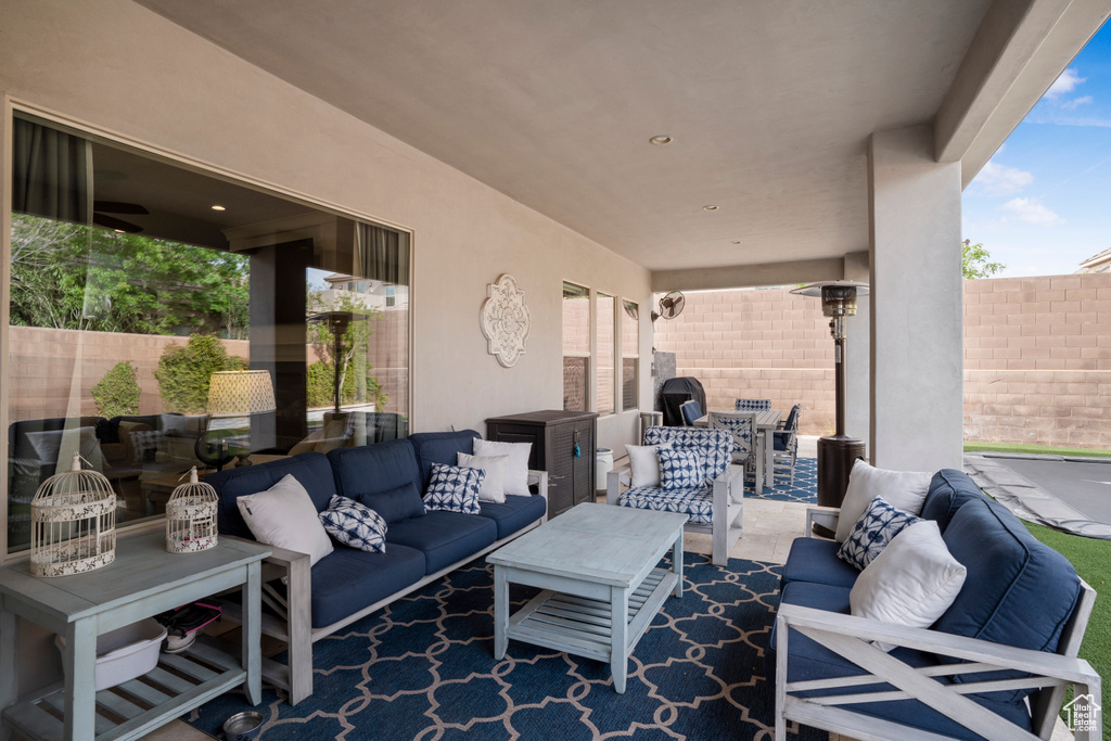 Fenced backyard with an outdoor living space, a patio, and outdoor dining area