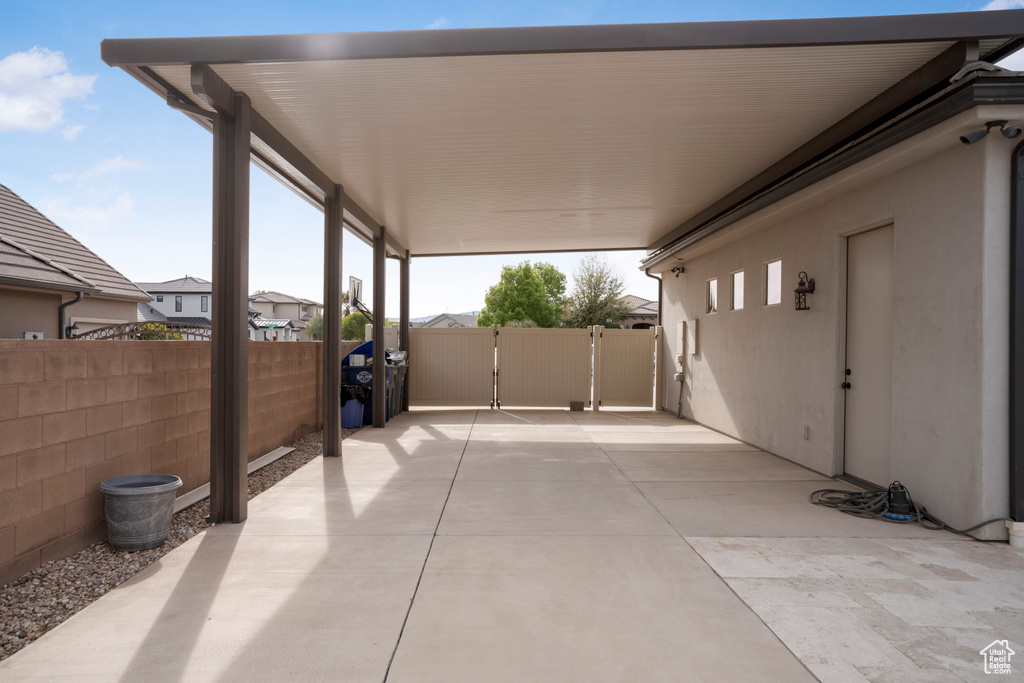 View of patio featuring a gate and an attached carport