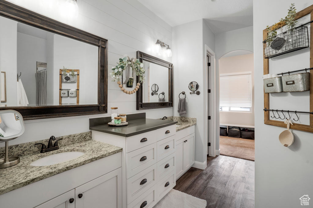 Bathroom with wood finished floors and vanity