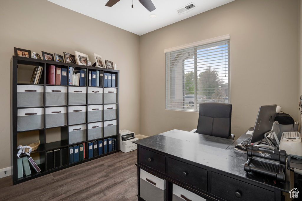 Office space with ceiling fan and dark wood-style floors