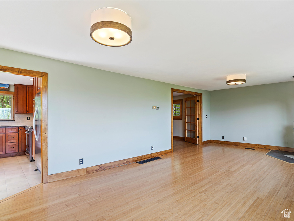 Unfurnished room featuring baseboards and light wood-style floors