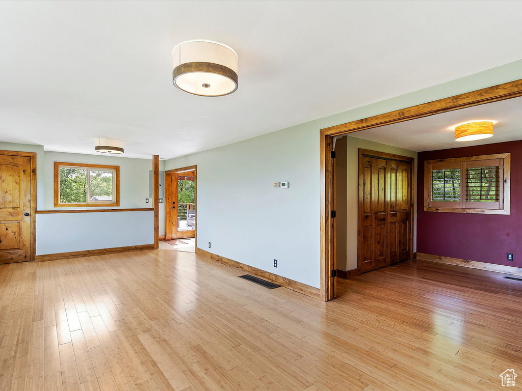Unfurnished room featuring baseboards and light wood-style flooring
