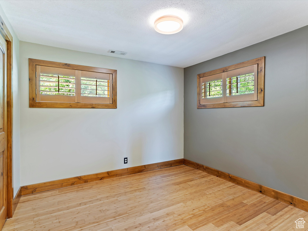 Unfurnished room with baseboards and light wood finished floors