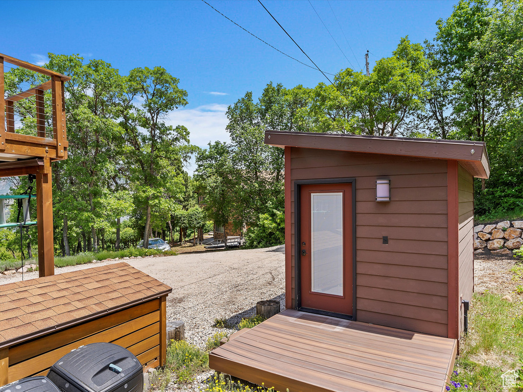Wooden deck featuring an outdoor structure