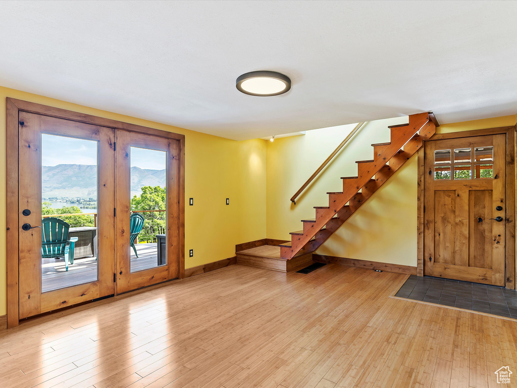 Entrance foyer featuring hardwood / wood-style floors, baseboards, and healthy amount of natural light
