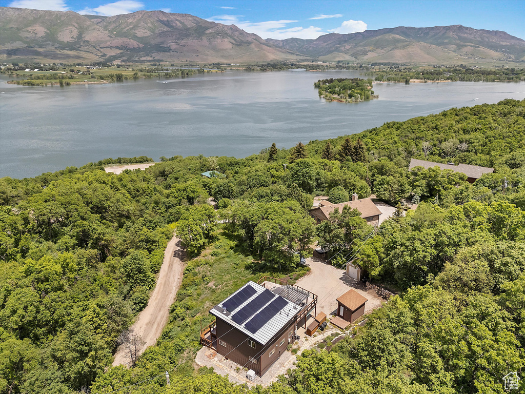 Drone / aerial view of a water and mountain view and a heavily wooded area