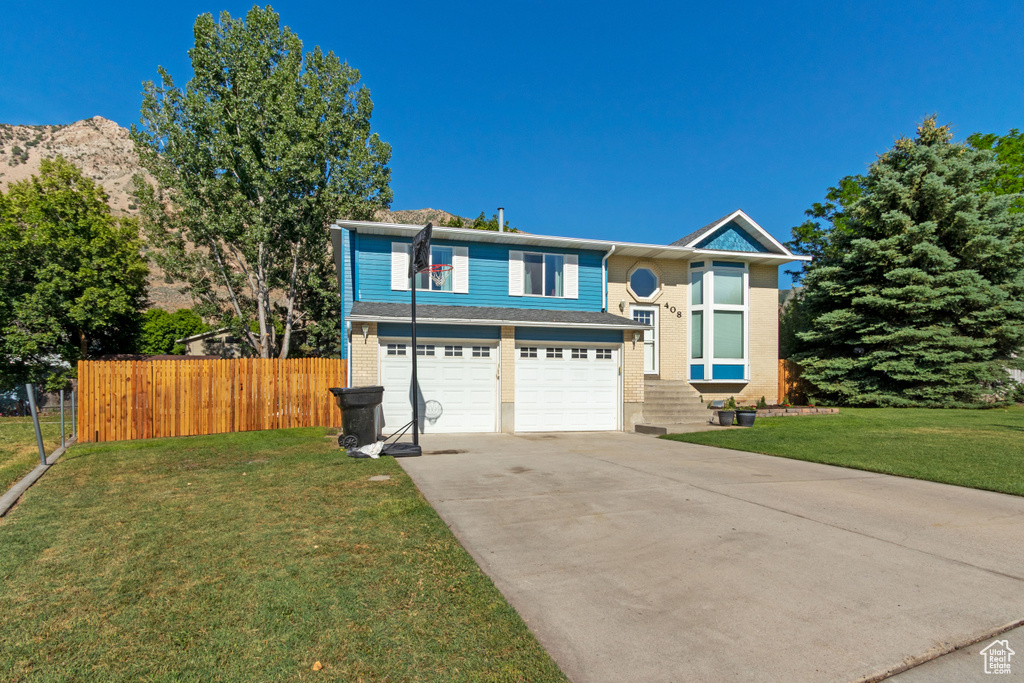 View of front of home with driveway and a garage