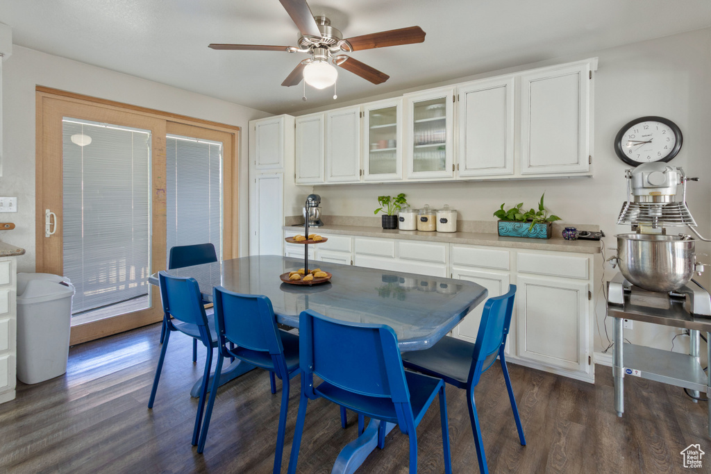 Dining space with dark wood-type flooring and ceiling fan