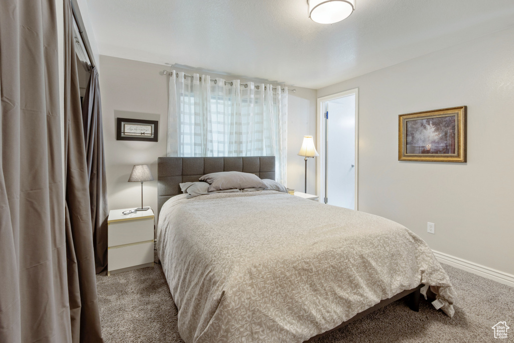 Carpeted bedroom with baseboards