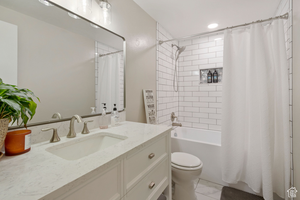 Bathroom with vanity, toilet, and shower / tub combo