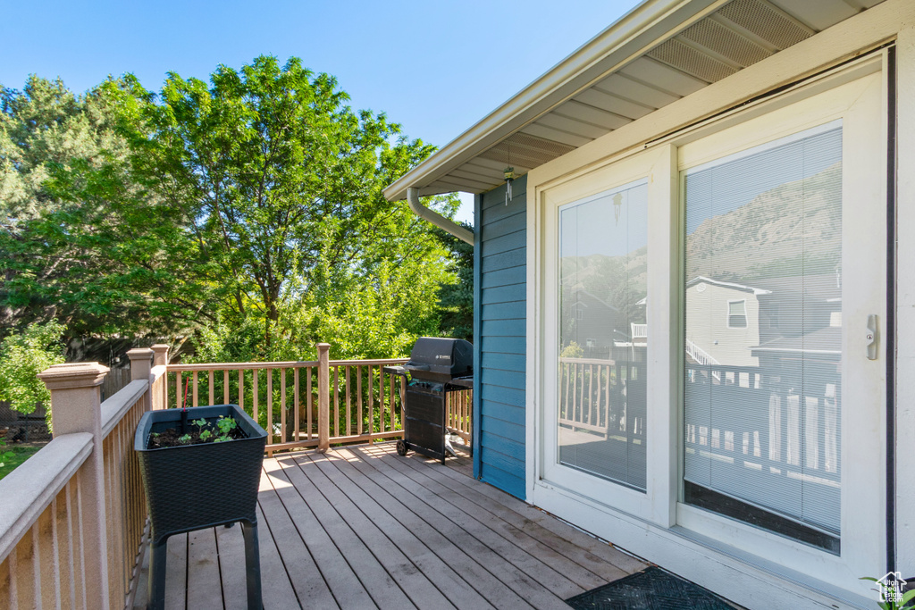 Wooden terrace featuring area for grilling