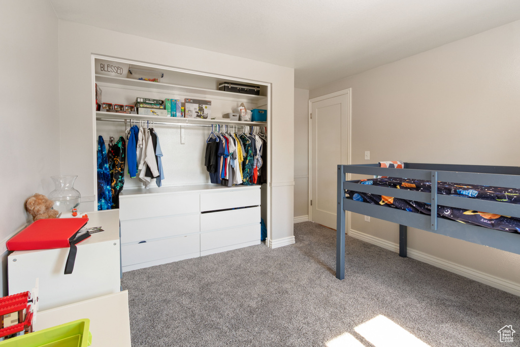 Carpeted bedroom with a closet