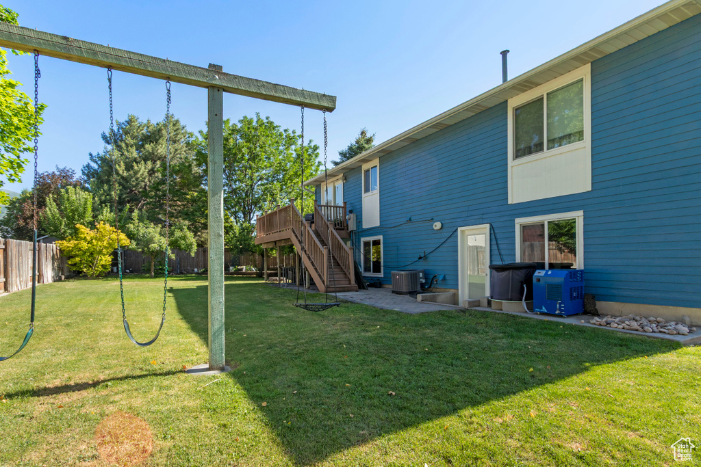 Rear view of property featuring stairway, a wooden deck, cooling unit, and a patio