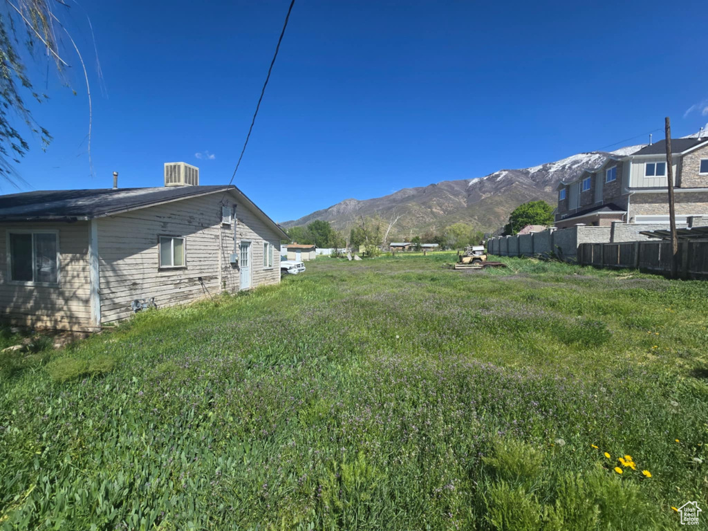 View of yard with a mountain view and cooling unit