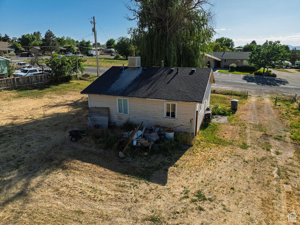 View of property exterior with a shingled roof and a residential view