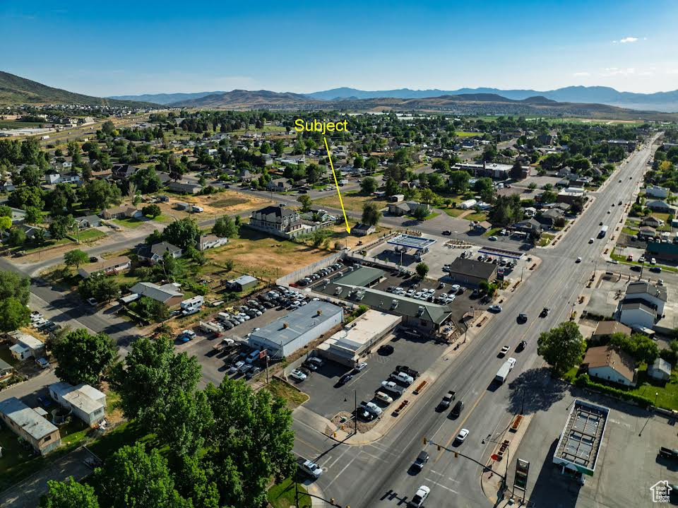 Aerial view of property's location featuring a mountainous background