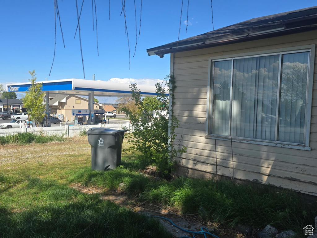 View of side of home with a yard
