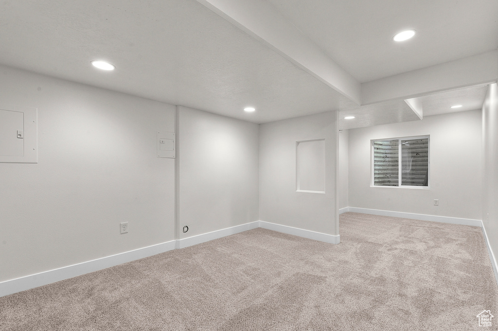 Spare room featuring light carpet, recessed lighting, and baseboards