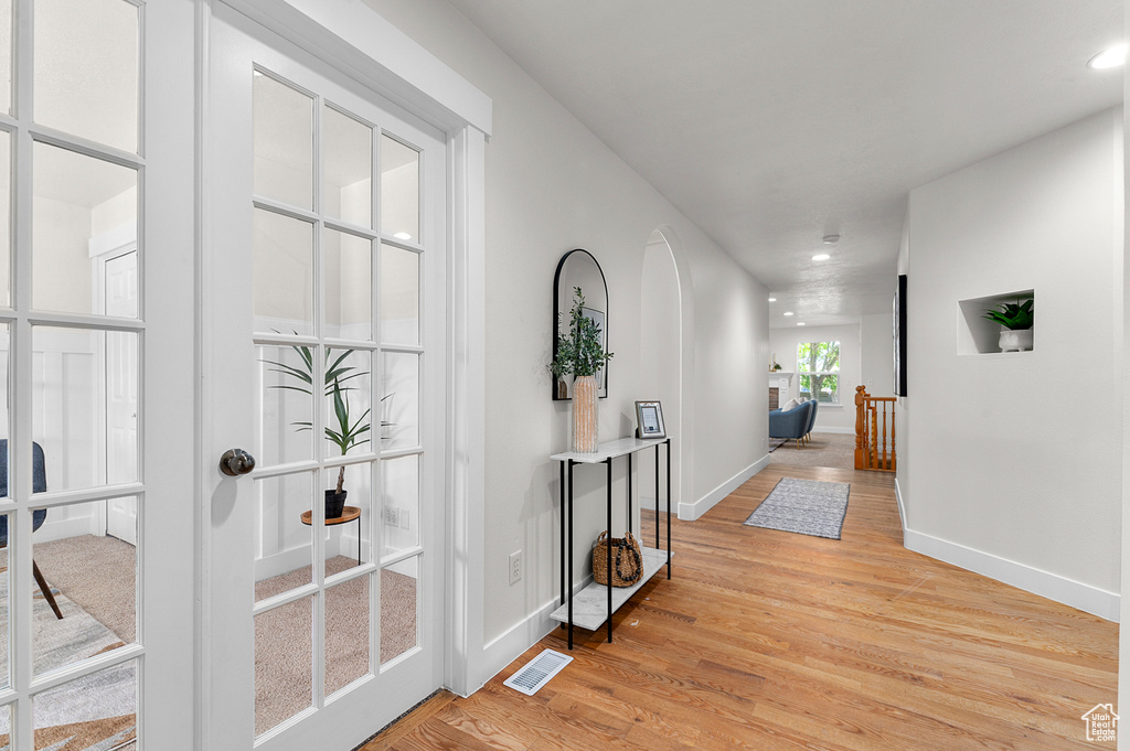Hall with light wood-style flooring, baseboards, and recessed lighting