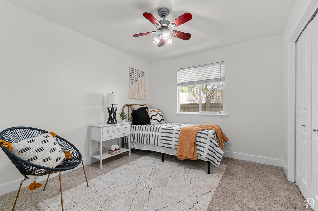 Bedroom featuring a closet, carpet, baseboards, and ceiling fan
