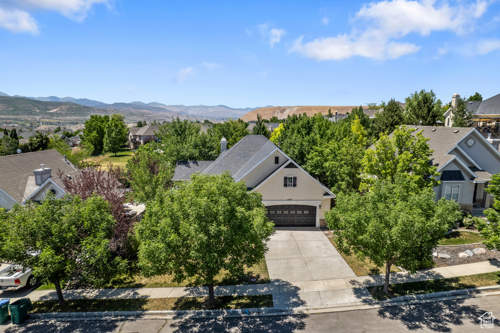 Aerial view of residential area featuring a mountainous background