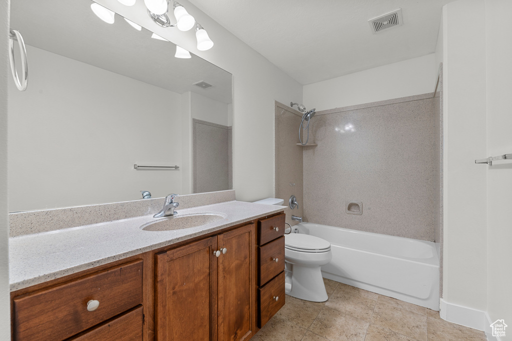 Full bathroom featuring vanity, toilet, and shower / tub combination