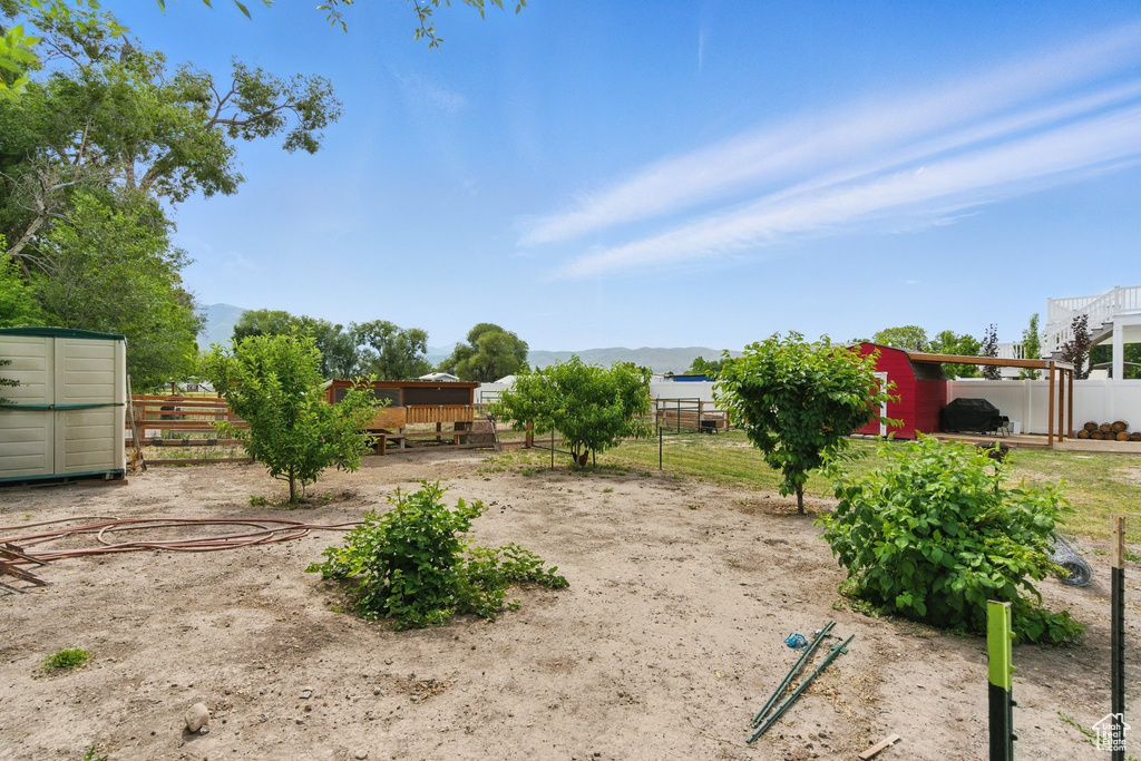 View of yard with an outdoor structure and a mountain view