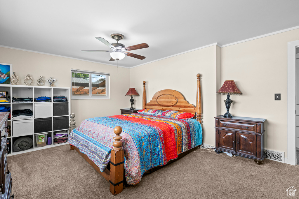 Bedroom with carpet, ornamental molding, and ceiling fan