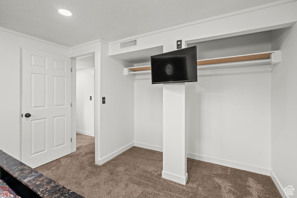 Unfurnished bedroom featuring carpet floors and baseboards