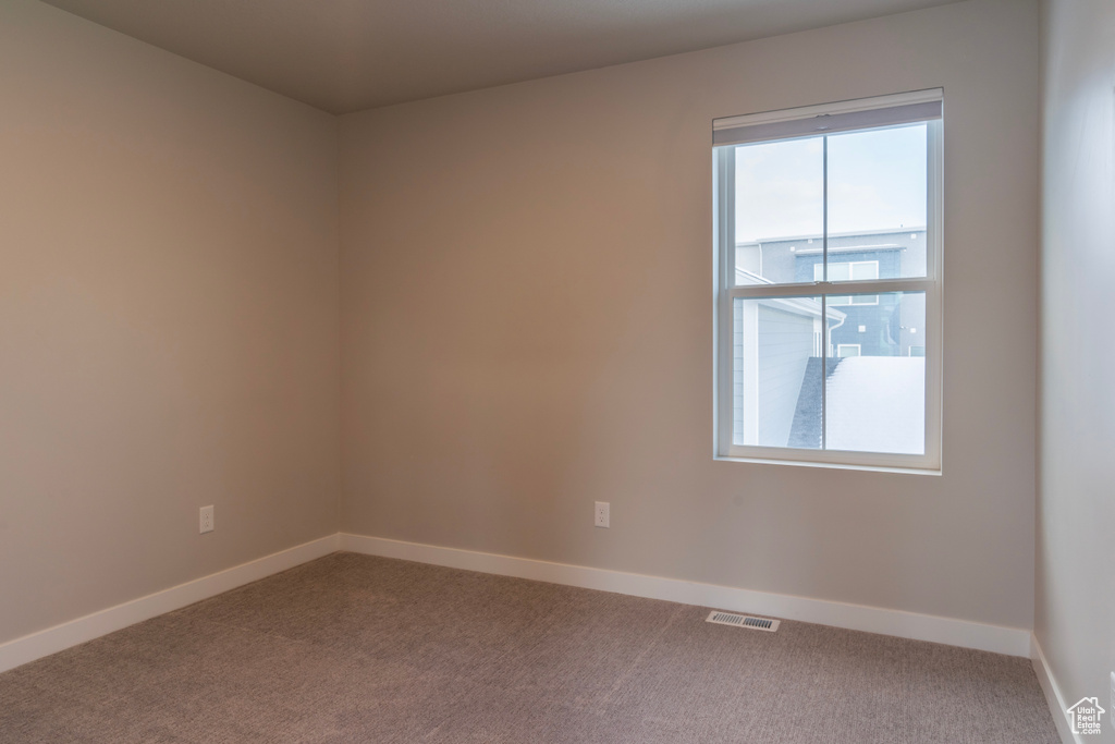 Spare room with carpet flooring and baseboards