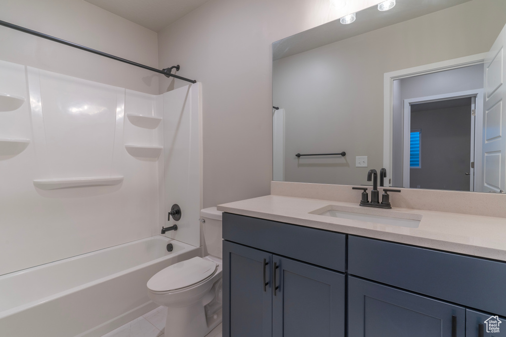 Full bath featuring toilet, vanity, shower / washtub combination, and tile patterned flooring
