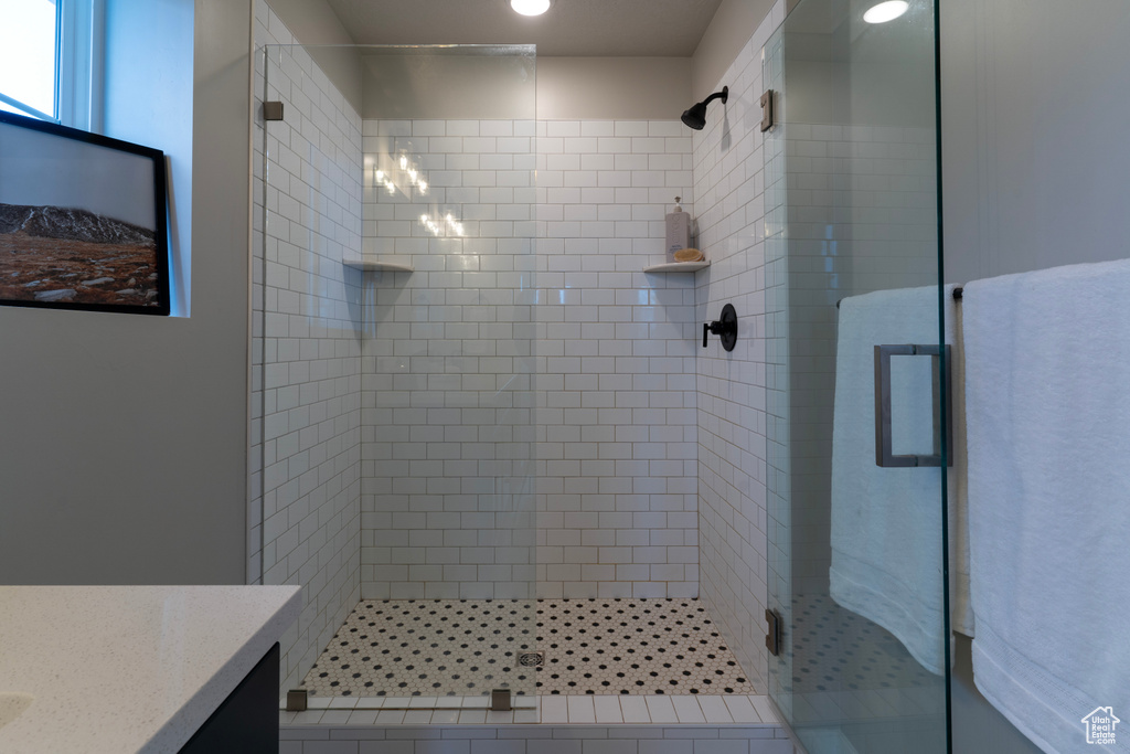 Full bath featuring a stall shower and vanity