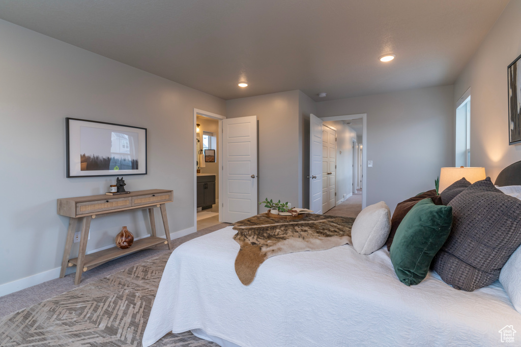 Bedroom with carpet flooring, baseboards, recessed lighting, and connected bathroom