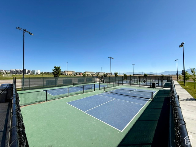 View of tennis court featuring a mountain view