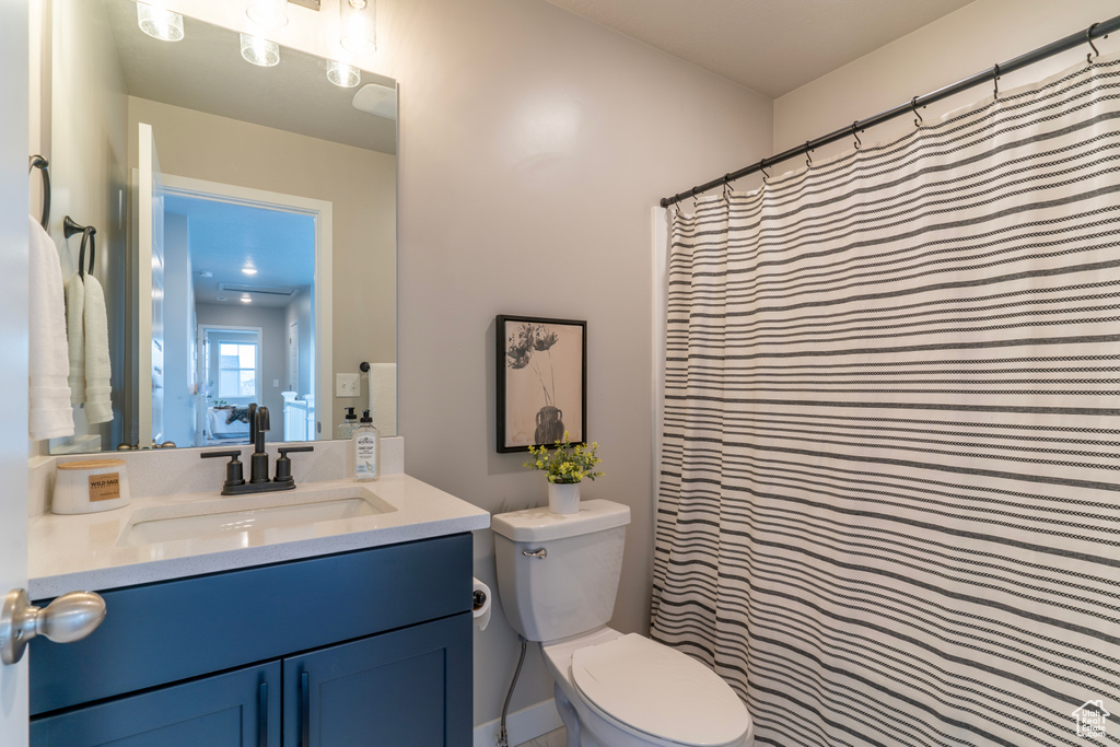 Full bathroom with toilet and vanity