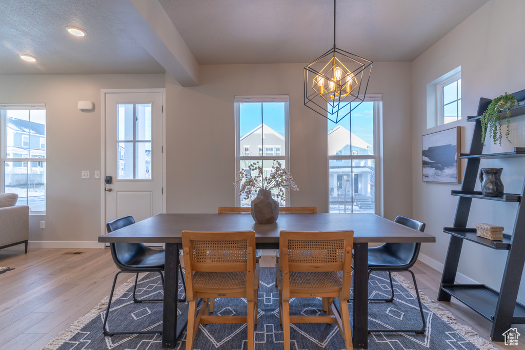 Dining space featuring a chandelier, plenty of natural light, light wood-type flooring, and recessed lighting
