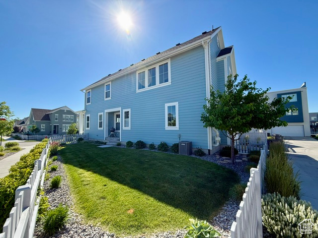 Rear view of house with central AC