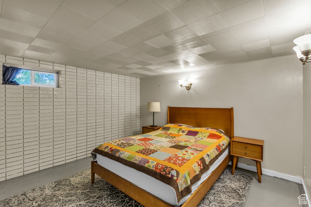 Bedroom featuring tile walls