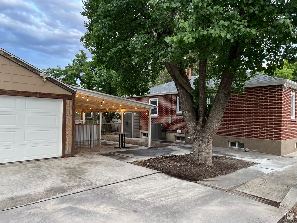 View of front of property featuring concrete driveway